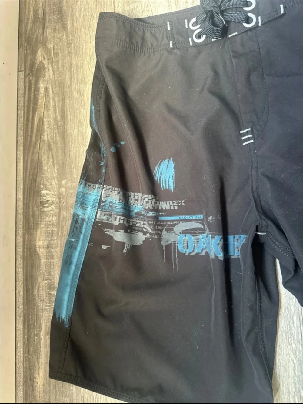 06 vintage Oakley Black Board Shorts with Blue Graphic Accents